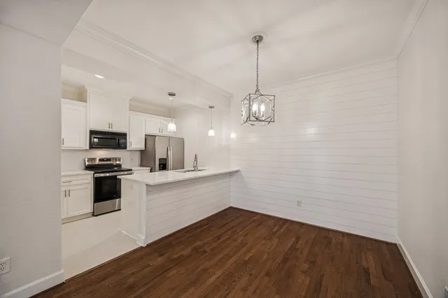 a kitchen with a sink stainless steel appliances and cabinets