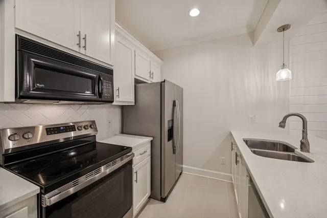 a kitchen with a refrigerator stove and microwave
