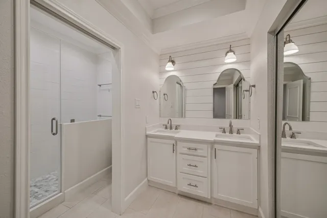 a spacious bathroom with a double vanity sink mirror and double