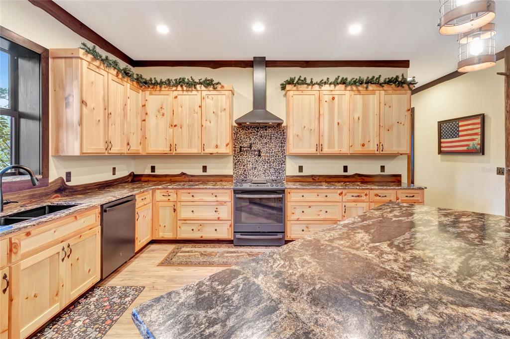7330 Crabgrass Road St. Cloud, FL 34773 - Photo 9 of 60 a kitchen with stainless steel appliances granite countertop a stove a sink and a refrigerator