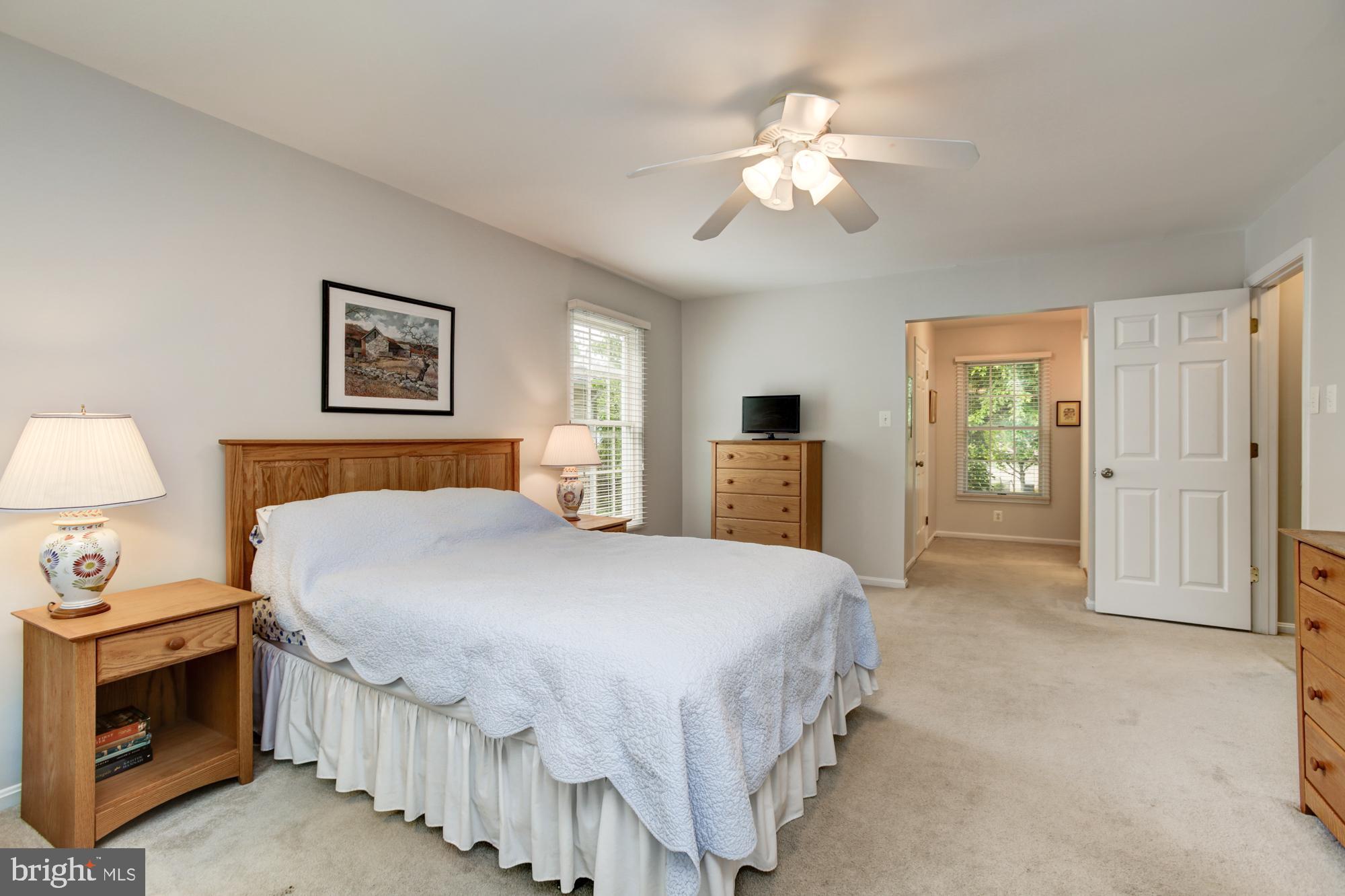326 Riding Ridge Road Annapolis, MD 21403 - Photo 27 of 63 a spacious bedroom with a bed and a chandelier
