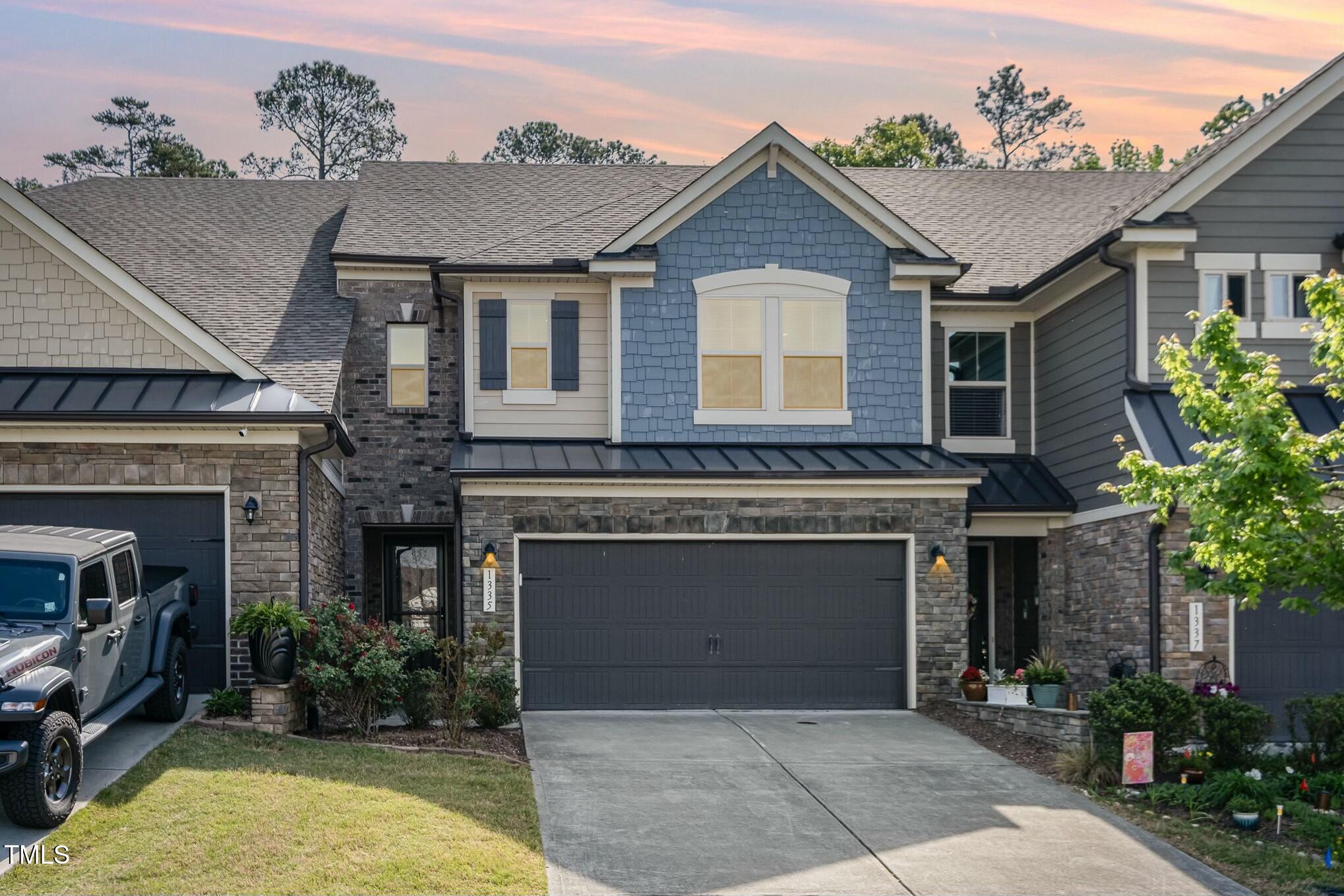 a front view of a house with plants