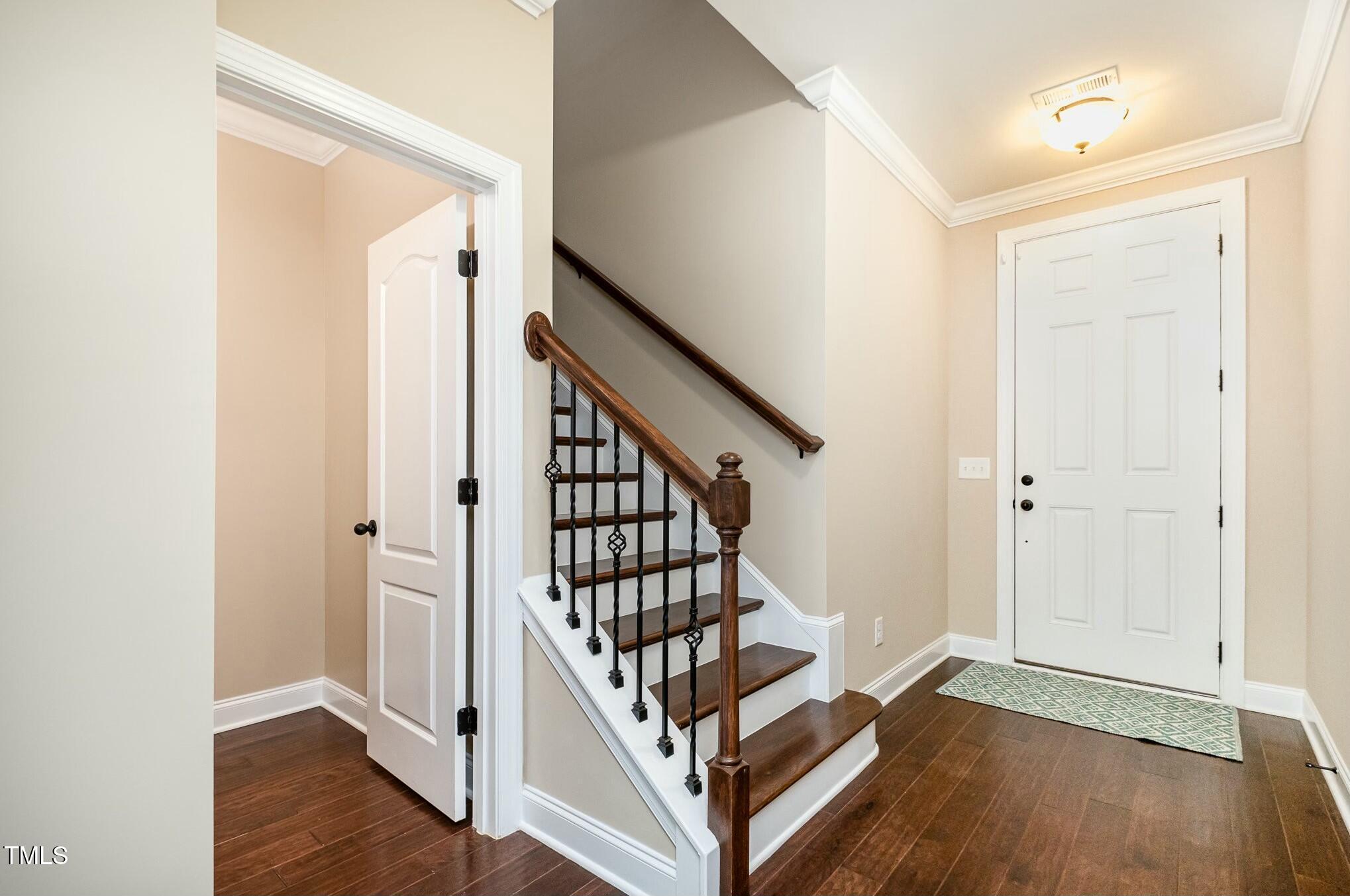1335 Catch Fly Lane Durham, NC 27713 - Photo 5 of 30 a view of front door with wooden floor and stairs