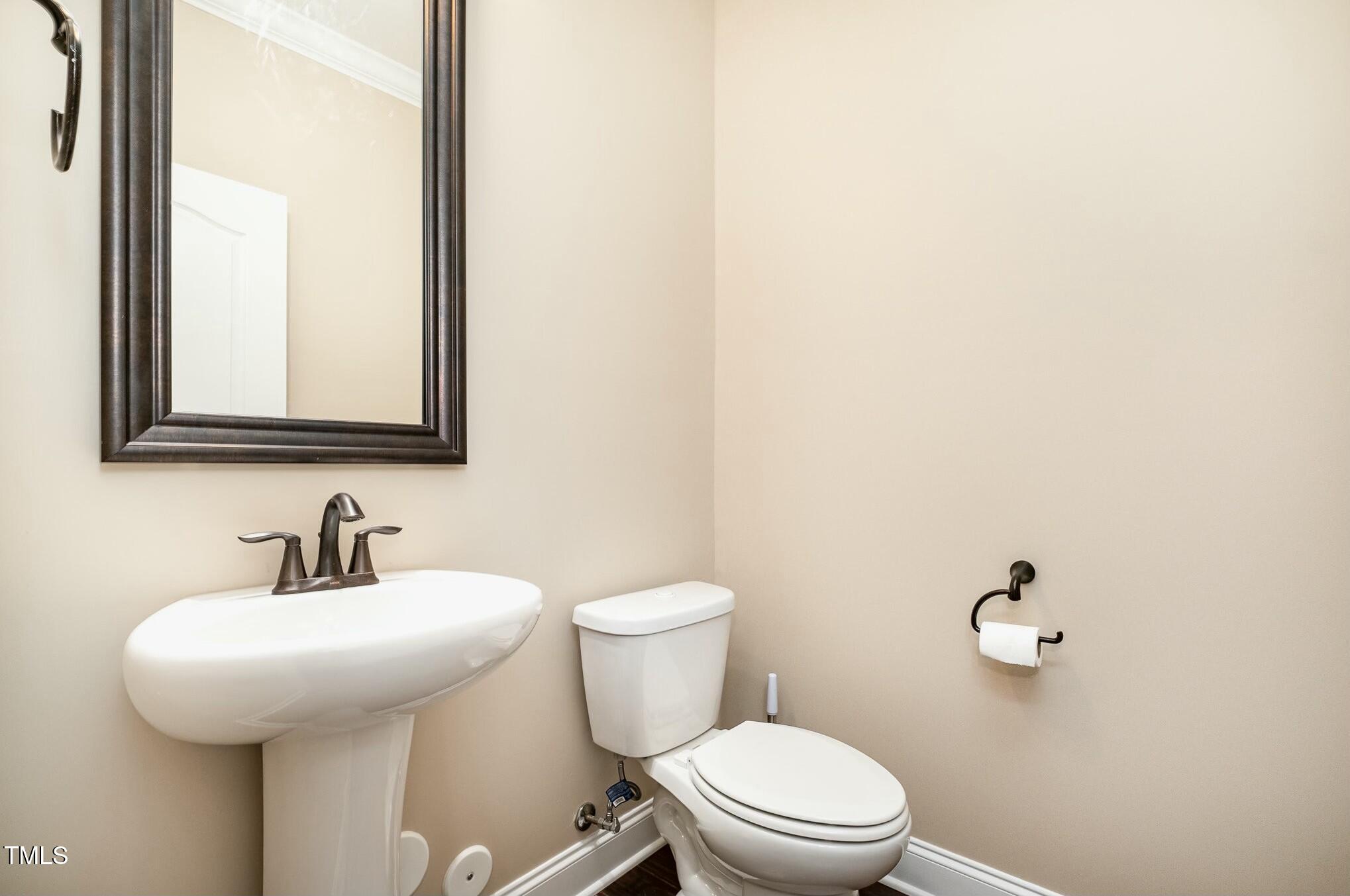 1335 Catch Fly Lane Durham, NC 27713 - Photo 8 of 30 a bathroom with a toilet a sink and mirror