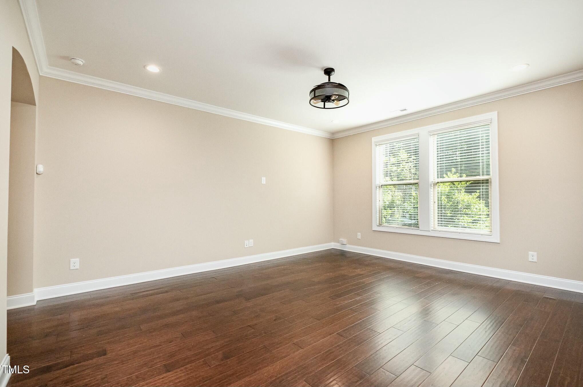 1335 Catch Fly Lane Durham, NC 27713 - Photo 10 of 30 an empty room with wooden floor and windows
