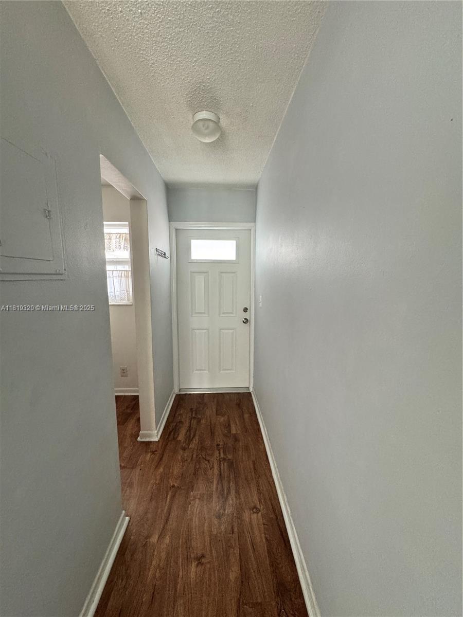 2701 Northeast 1st Street, Unit 203 Pompano Beach, FL 33062 - Photo 13 of 16 a view of a hallway with wooden floor