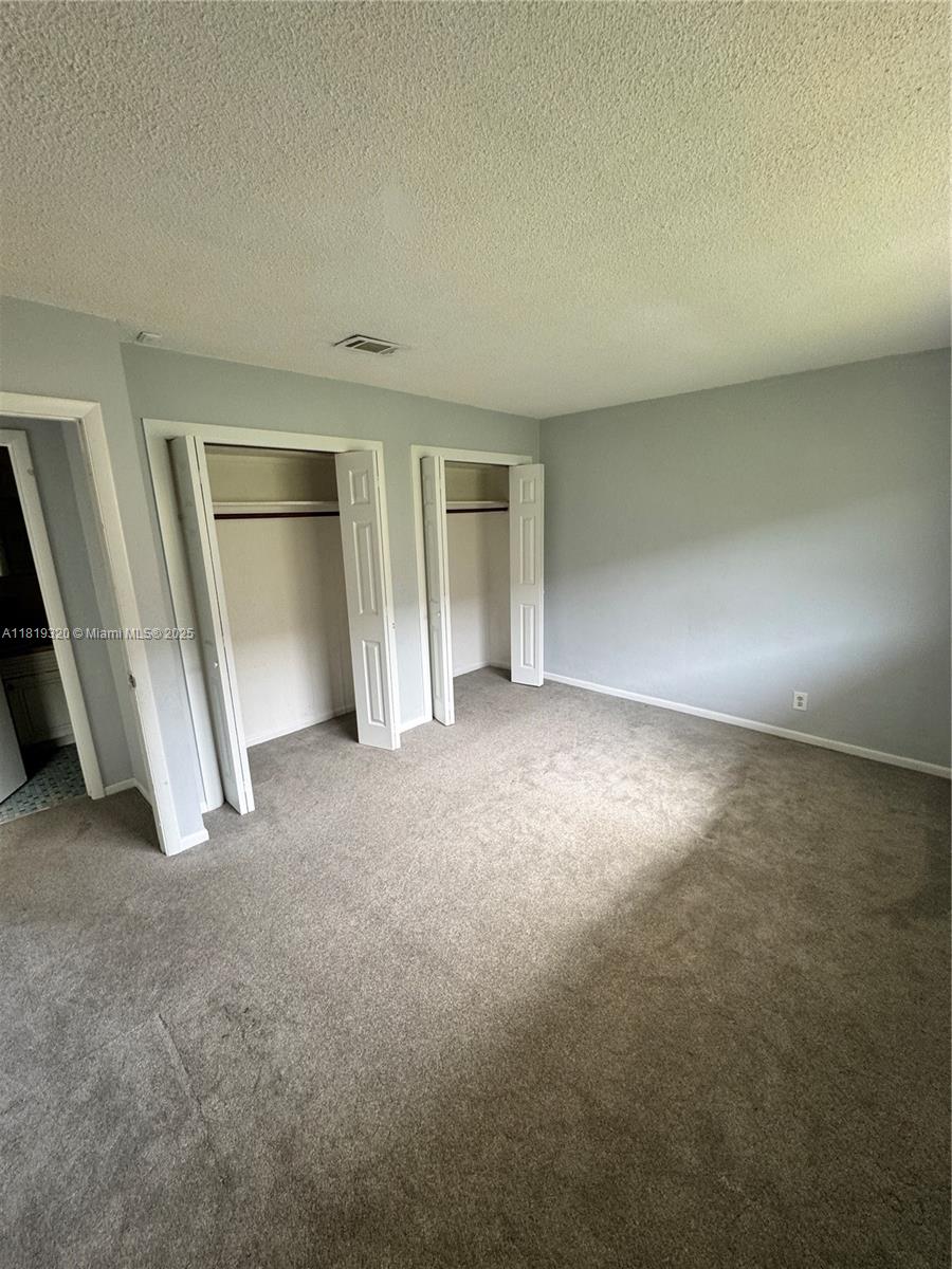 2701 Northeast 1st Street, Unit 203 Pompano Beach, FL 33062 - Photo 4 of 16 an empty room with a natural light
