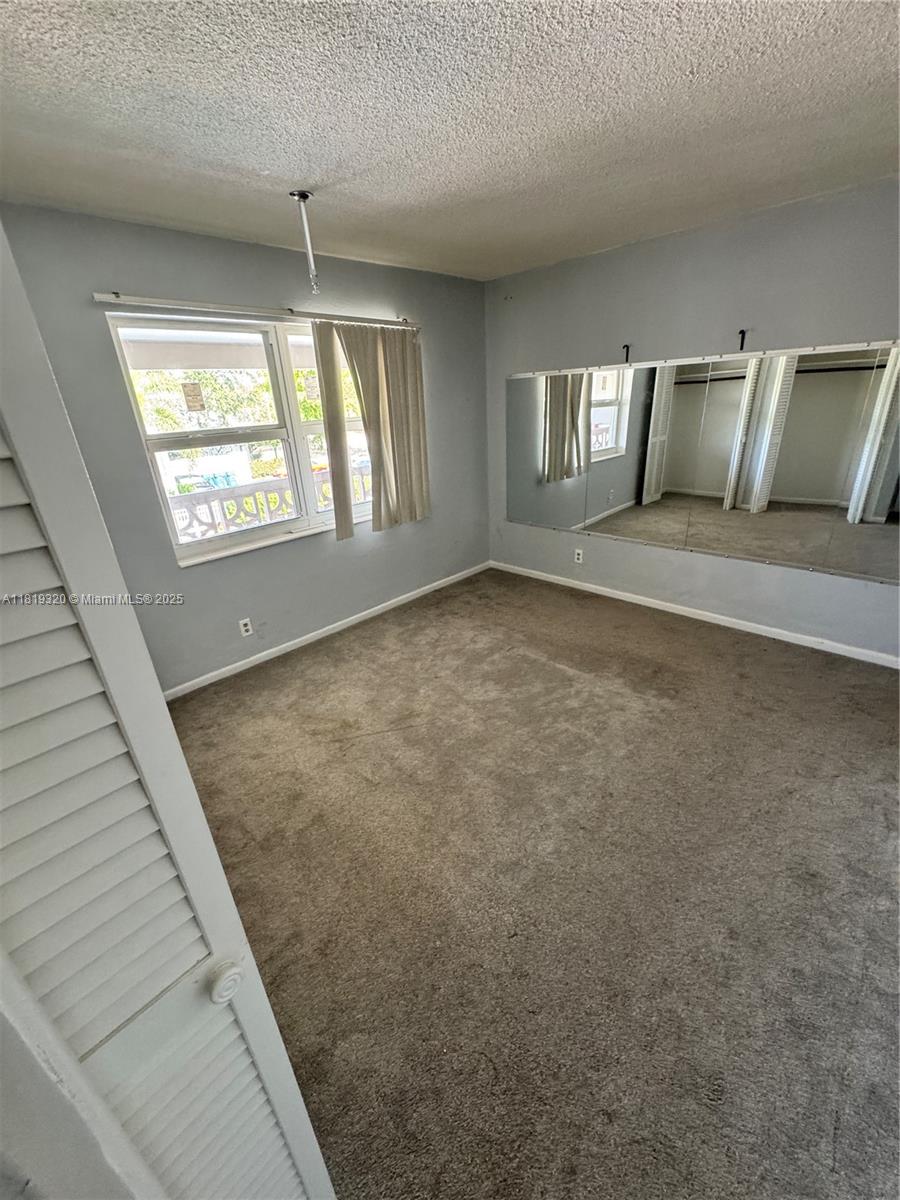 2701 Northeast 1st Street, Unit 203 Pompano Beach, FL 33062 - Photo 9 of 16 a view of an empty room and window