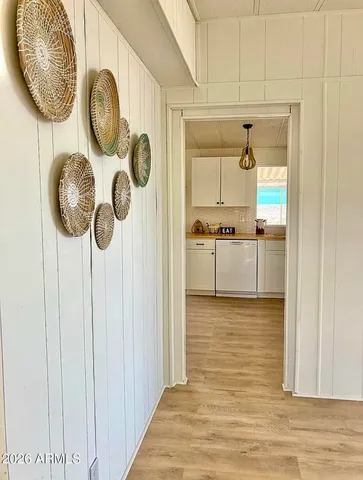 a view of a kitchen with wooden floor and a window