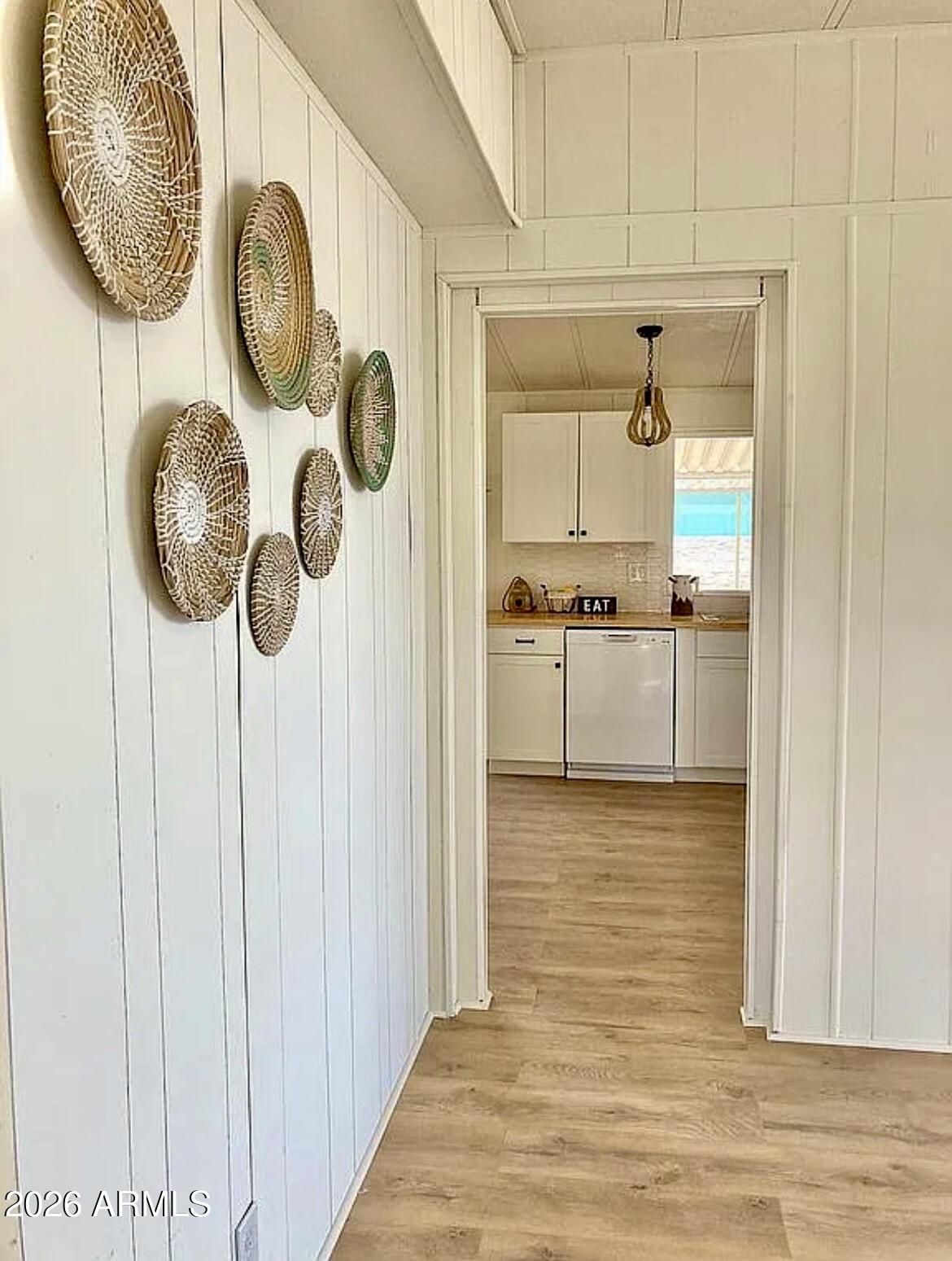 a view of a kitchen with wooden floor and a window