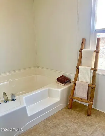 a bathroom with a window and a bathtub