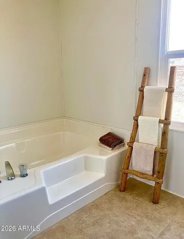 a bathroom with a window and a bathtub