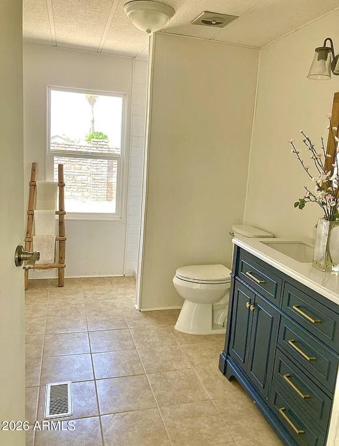 13245 East 39th Way Yuma, AZ 85367 - Photo 15 of 24 a bathroom with a sink a toilet and a window