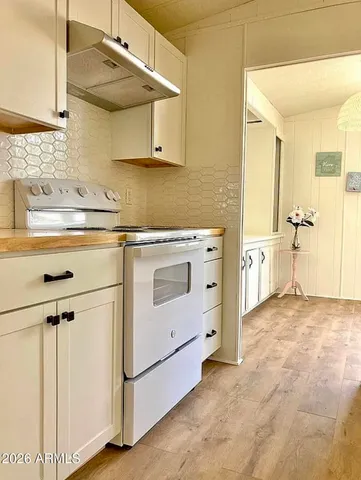 a kitchen with cabinets and a stove