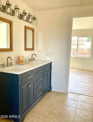 a bathroom with a sink double vanity and a mirror