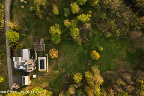 a living room with furniture and floor to ceiling windows