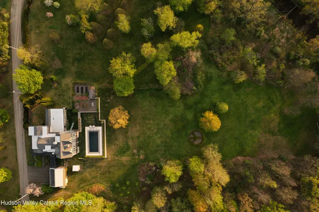 a living room with furniture and floor to ceiling windows