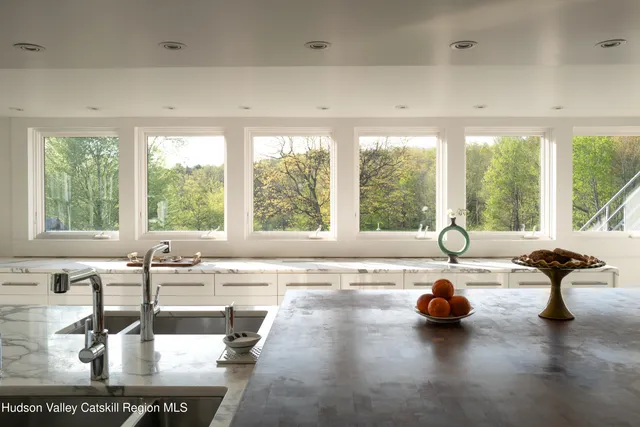 a kitchen with stainless steel appliances kitchen island granite countertop a stove and cabinets