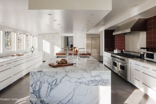 a living room with furniture a window and wooden floor