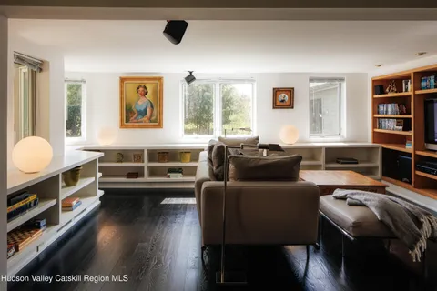 a view of a workspace with furniture and a window