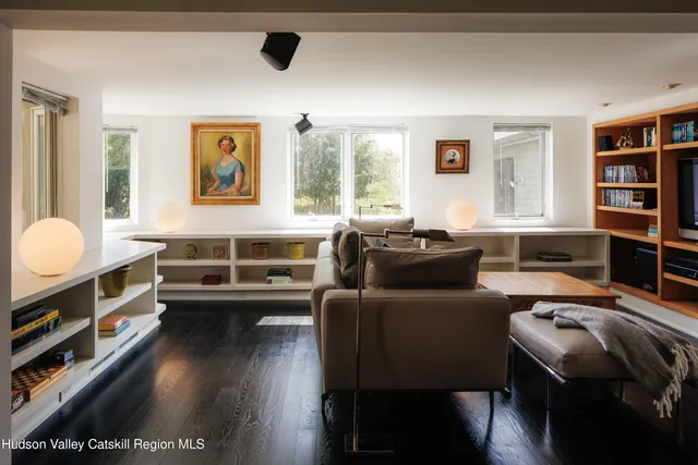 a view of a workspace with furniture and a window