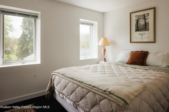 a bedroom with a large bed and a window