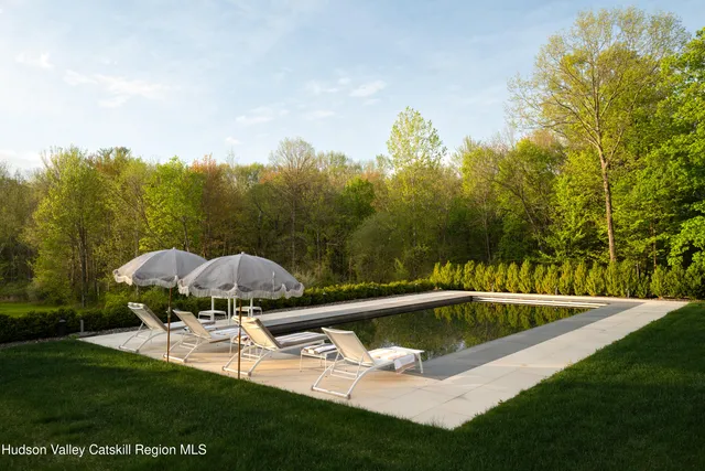 a view of a swimming pool with a yard