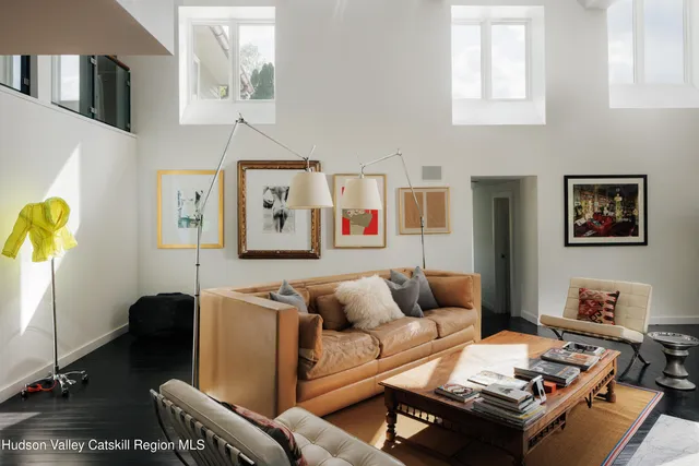 a living room with furniture rug and lamp