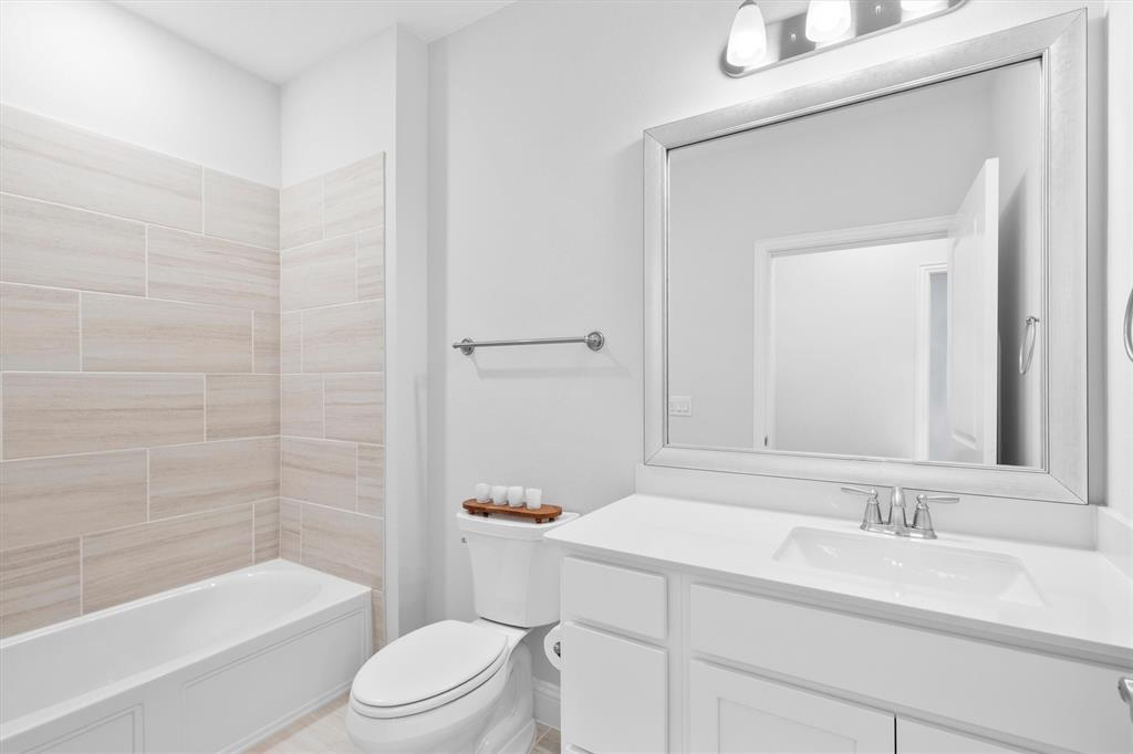 651 Watters Road, Unit 4403 Allen, TX 75013 - Photo 26 of 37 a bathroom with a bathtub shower sink vanity mirror and toilet