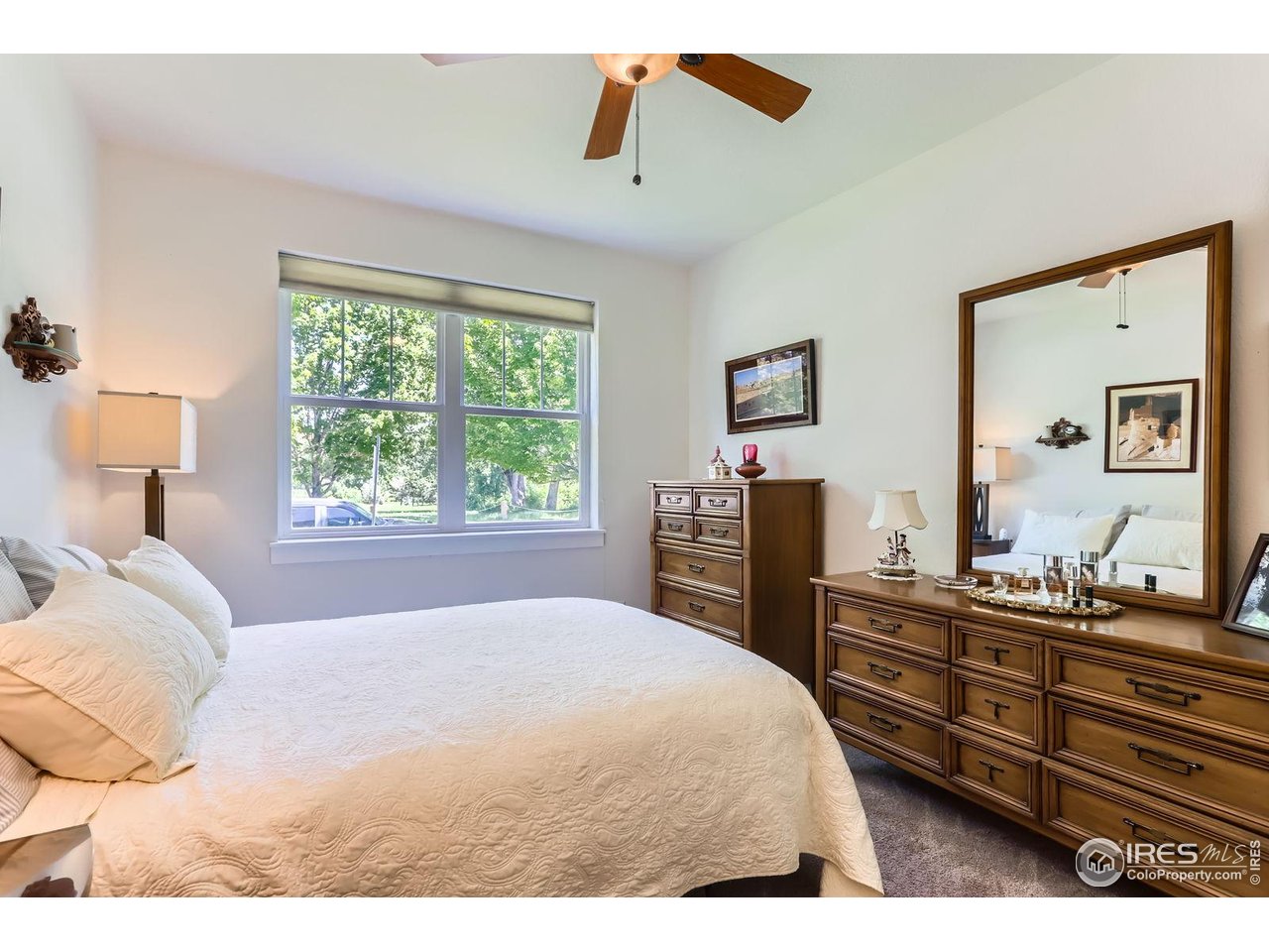 193 2nd Avenue, Unit A Lyons, CO 80540 - Photo 12 of 40 a bedroom with a bed and dresser with mirror