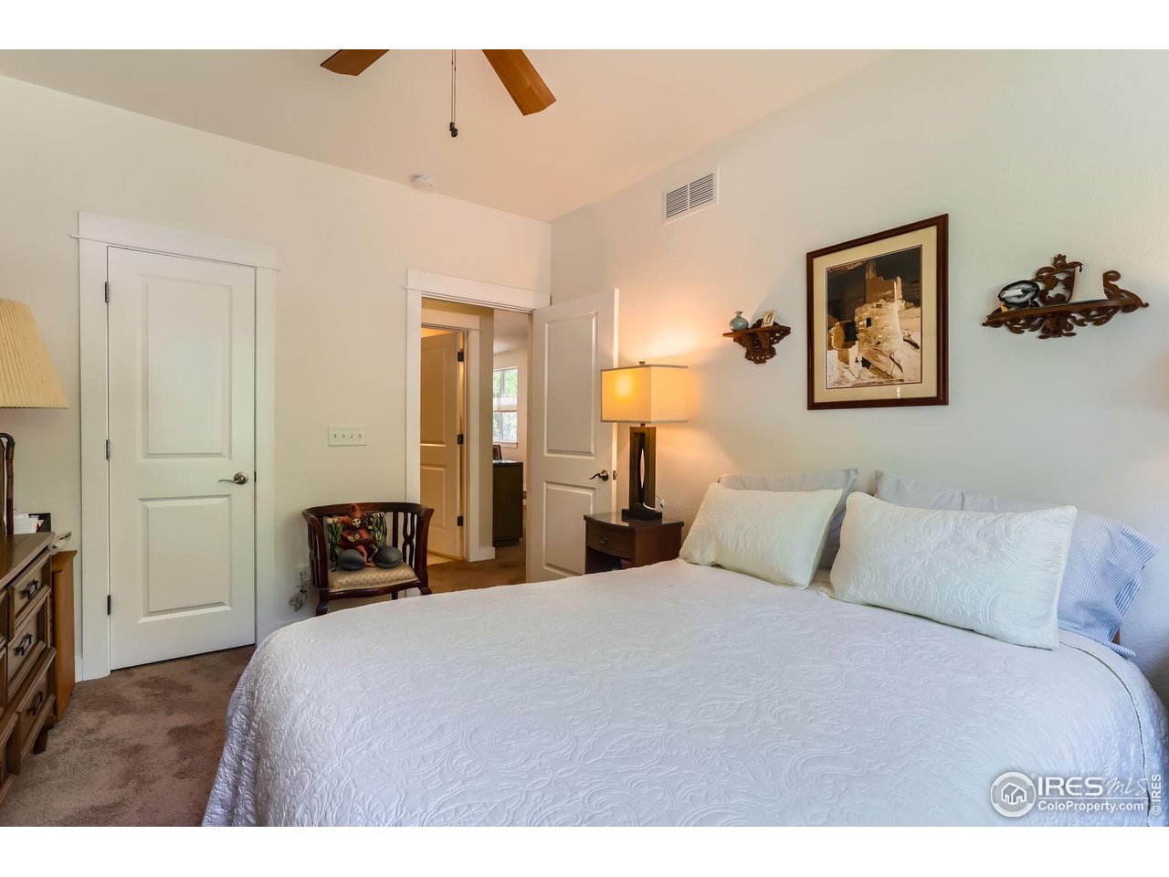 193 2nd Avenue, Unit A Lyons, CO 80540 - Photo 13 of 40 a bedroom with a bed and a painting on the wall