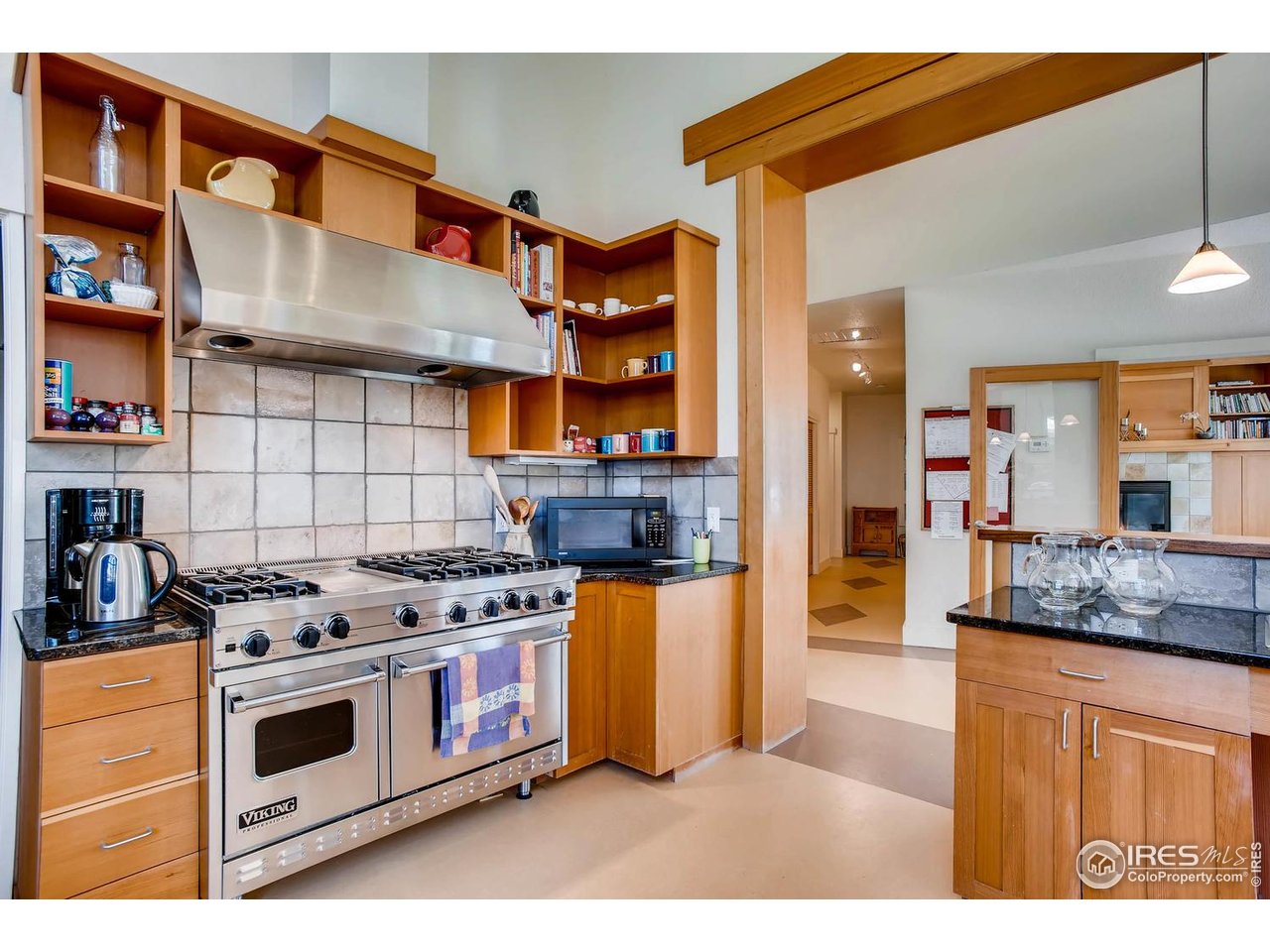 193 2nd Avenue, Unit A Lyons, CO 80540 - Photo 21 of 40 a kitchen with stainless steel appliances granite countertop a stove and cabinets