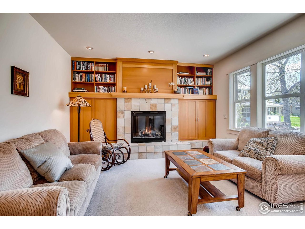 193 2nd Avenue, Unit A Lyons, CO 80540 - Photo 23 of 40 a living room with furniture a fireplace and a large window