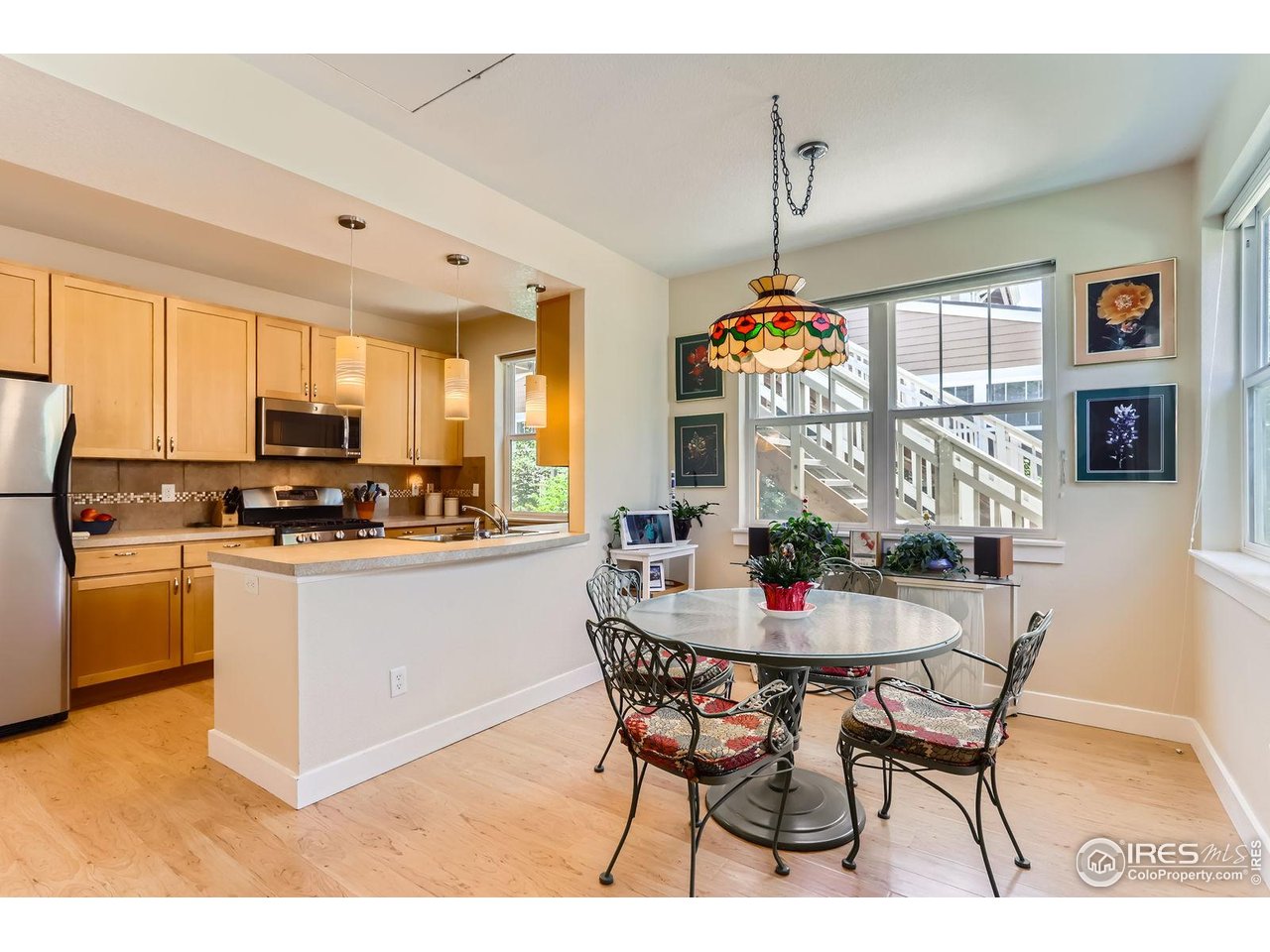 193 2nd Avenue, Unit A Lyons, CO 80540 - Photo 8 of 40 a kitchen with stainless steel appliances granite countertop a stove top oven a sink a dining table and chairs