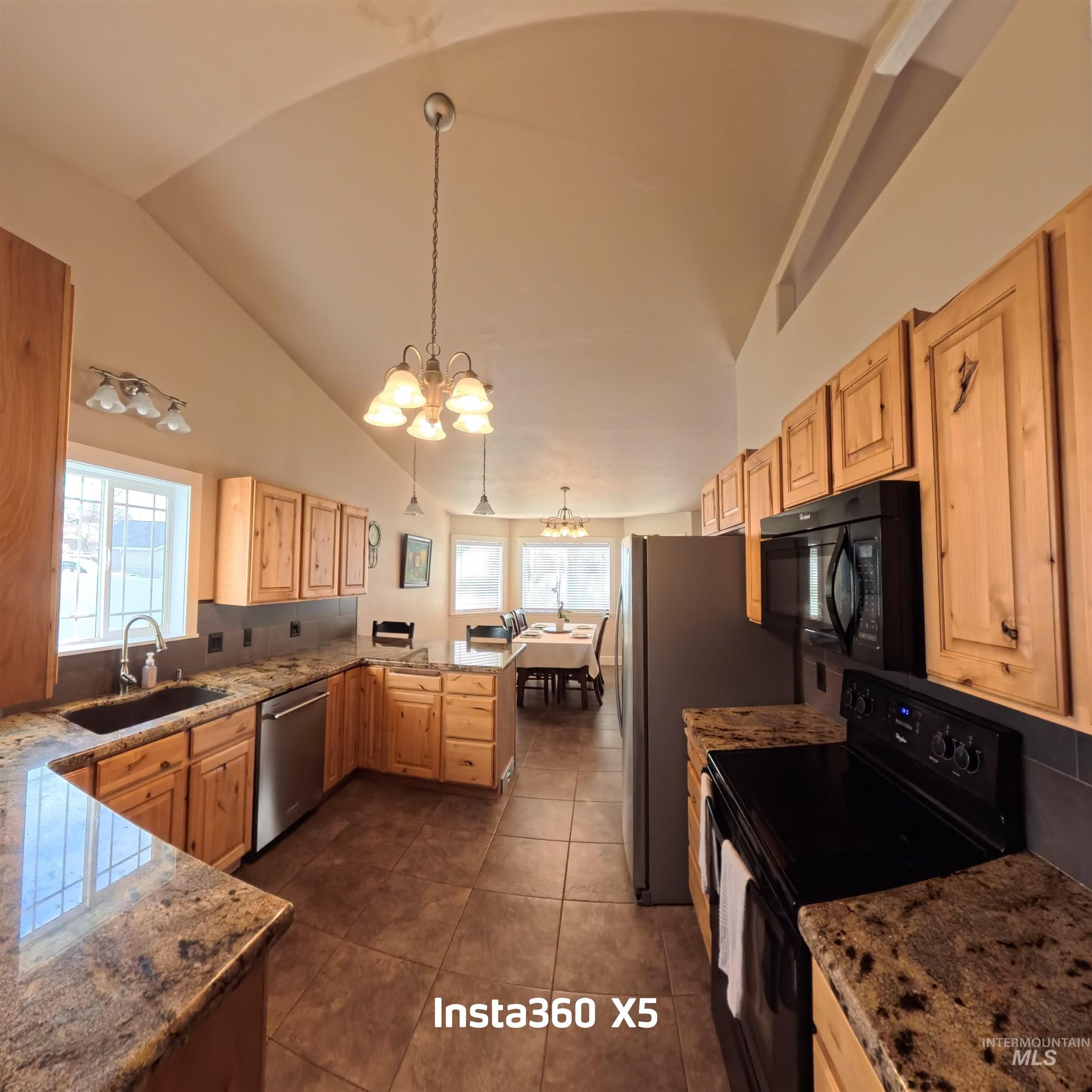 891 North Pointe Drive Twin Falls, ID 83301 - Photo 12 of 46 Kitchen featuring black appliances, a chandelier, hanging light fixtures, light brown cabinets, and light stone countertops