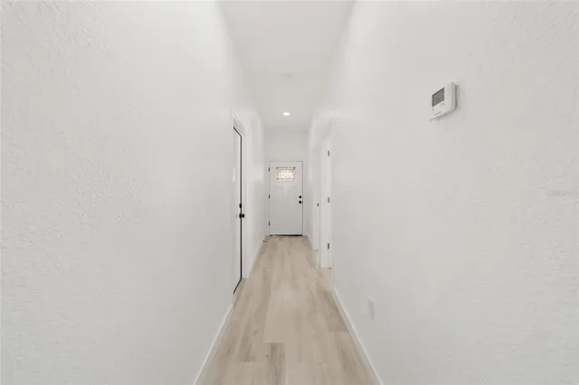a view of a hallway with wooden floor