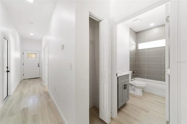 a bathroom with a granite countertop toilet a sink and a large mirror