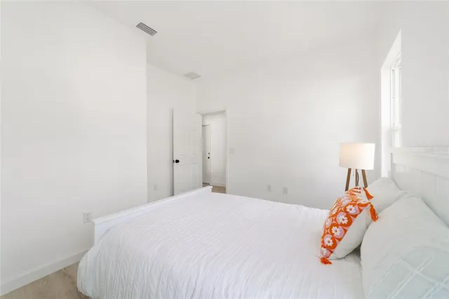 a bedroom with a bed and a night stand