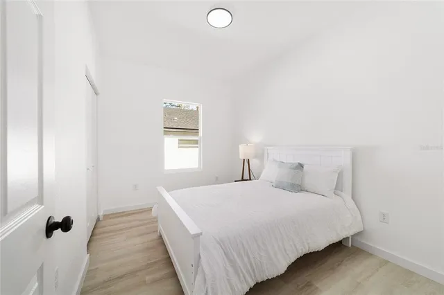 a bedroom with a bed and a window