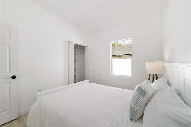 a bedroom with a bed and a night stand