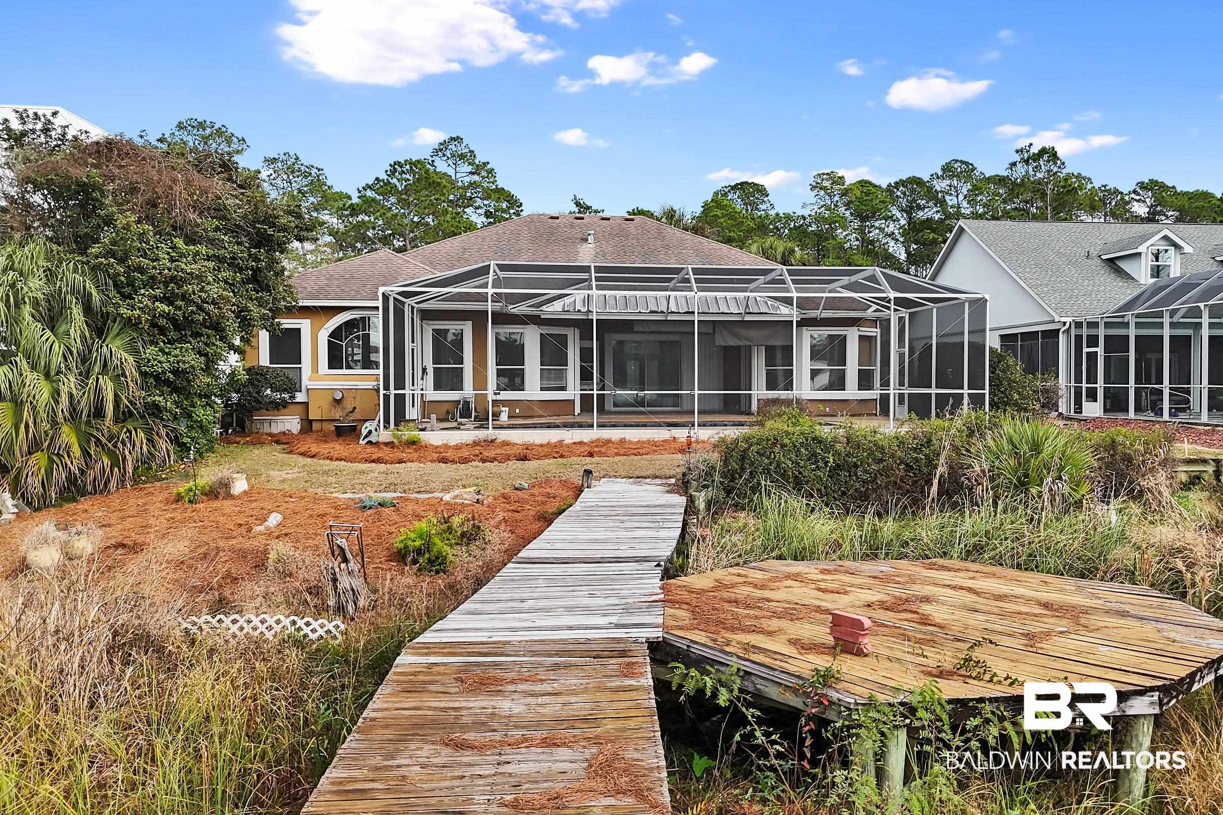 8591 Bay Harbor Road Elberta, AL 36530 - Photo 50 of 56 Back of house featuring a lanai, a sunroom, and a shingled roof