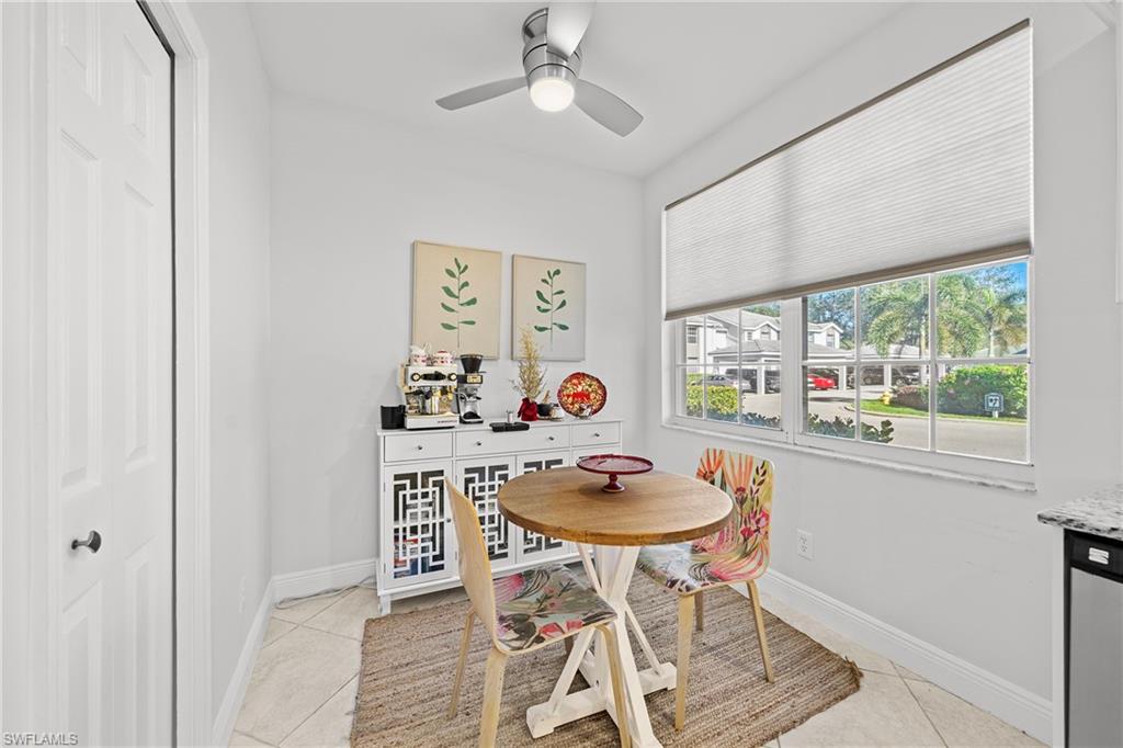 3780 Fieldstone Boulevard, Unit 301 Naples, FL 34109 - Photo 12 of 35 a dining room with furniture a window and wooden floor