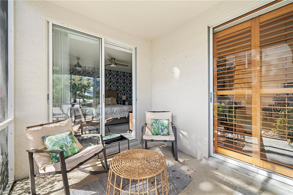3780 Fieldstone Boulevard, Unit 301 Naples, FL 34109 - Photo 17 of 35 a living room with furniture and a potted plant