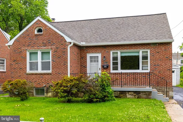 a front view of a house with a yard and outdoor seating