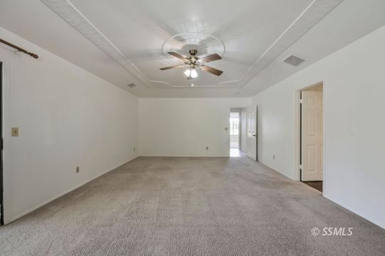 1257 Carolyn Street Ridgecrest, CA 93555 - Photo 26 of 42 a view of an empty room with a ceiling fan
