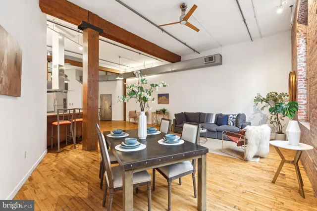 a dining room with furniture and wooden floor