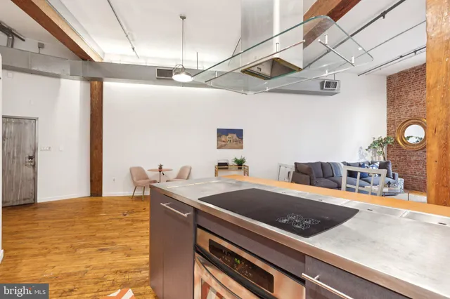 a view of a kitchen with kitchen island a counter place and a refrigerator