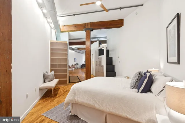 a bedroom with a bed and wooden floor