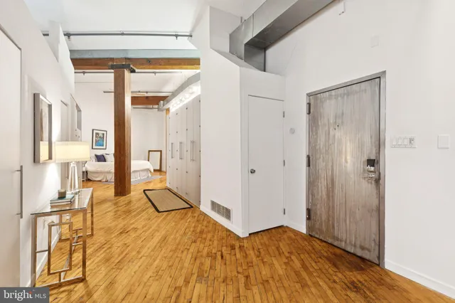 a view of an entryway with wooden floor and a livingroom view