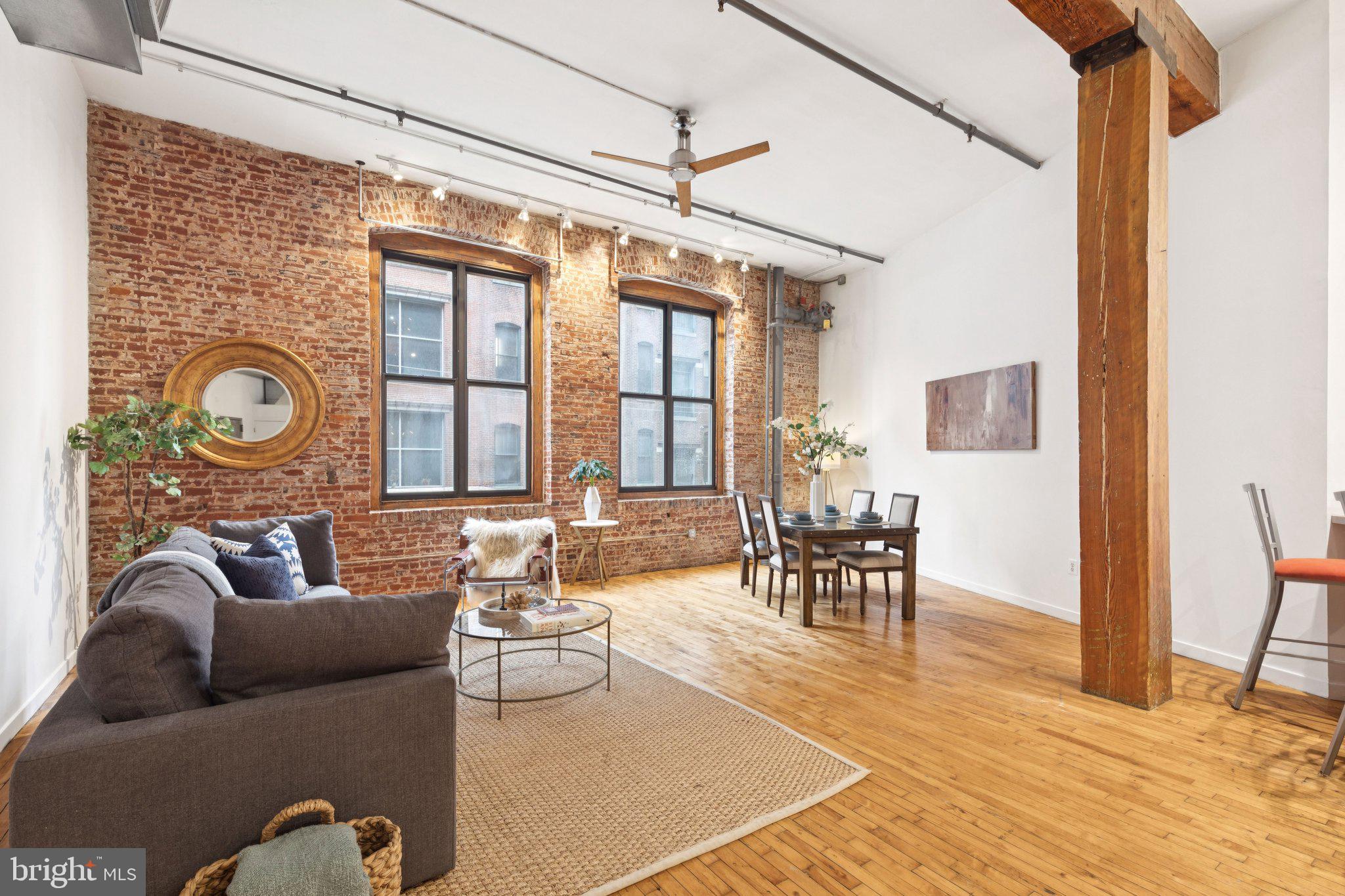 428 North 13th Street, Unit 3E Philadelphia, PA 19123 - Photo 3 of 44 a living room with furniture and a large window